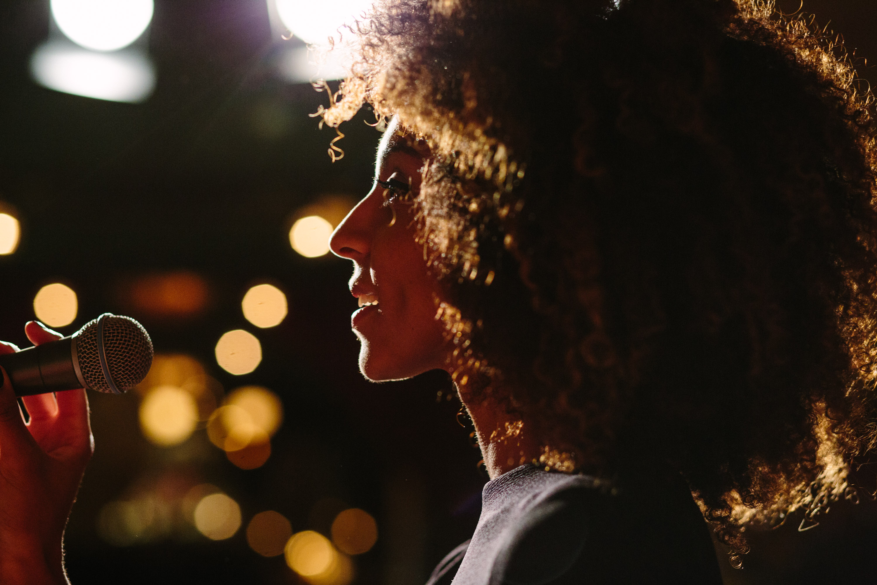 A woman singing into a microphone at The Django jazz club.