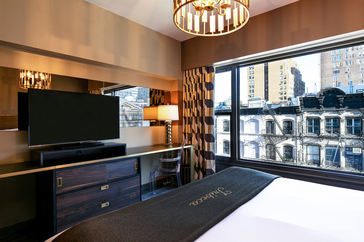deluxe king dresser and tv across from the king bed